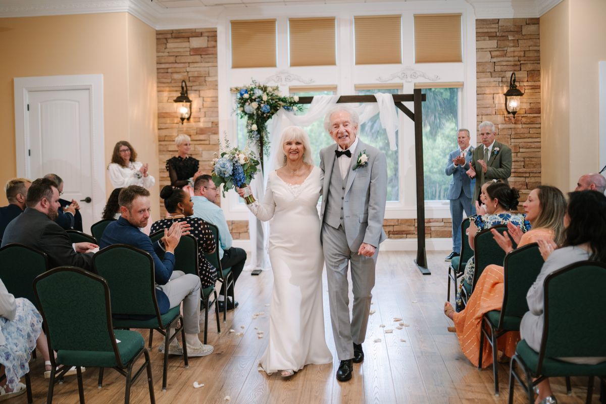 Elaine Hall and Roland Passaro walk down the aisle at their wedding ceremony in Palm Coast, Fla., last month.  (Courtesy of Maddy Godt)